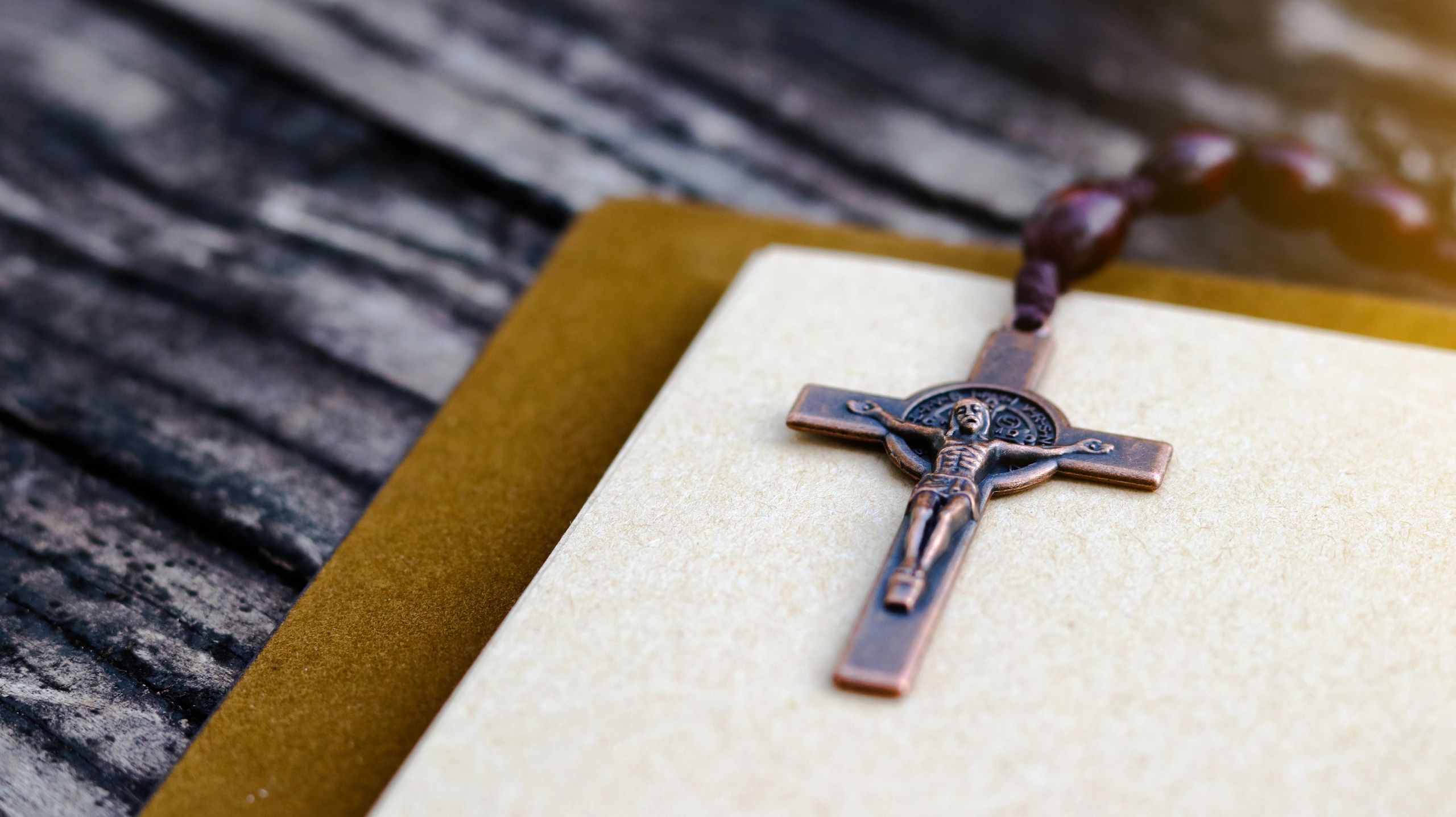 Cross and open book representing Christian inspiration